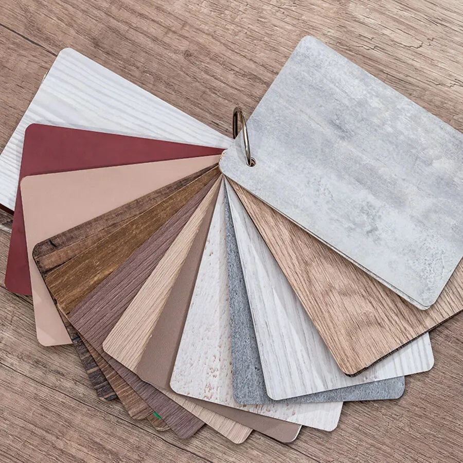 A fan of different types of wood samples on a wooden table.