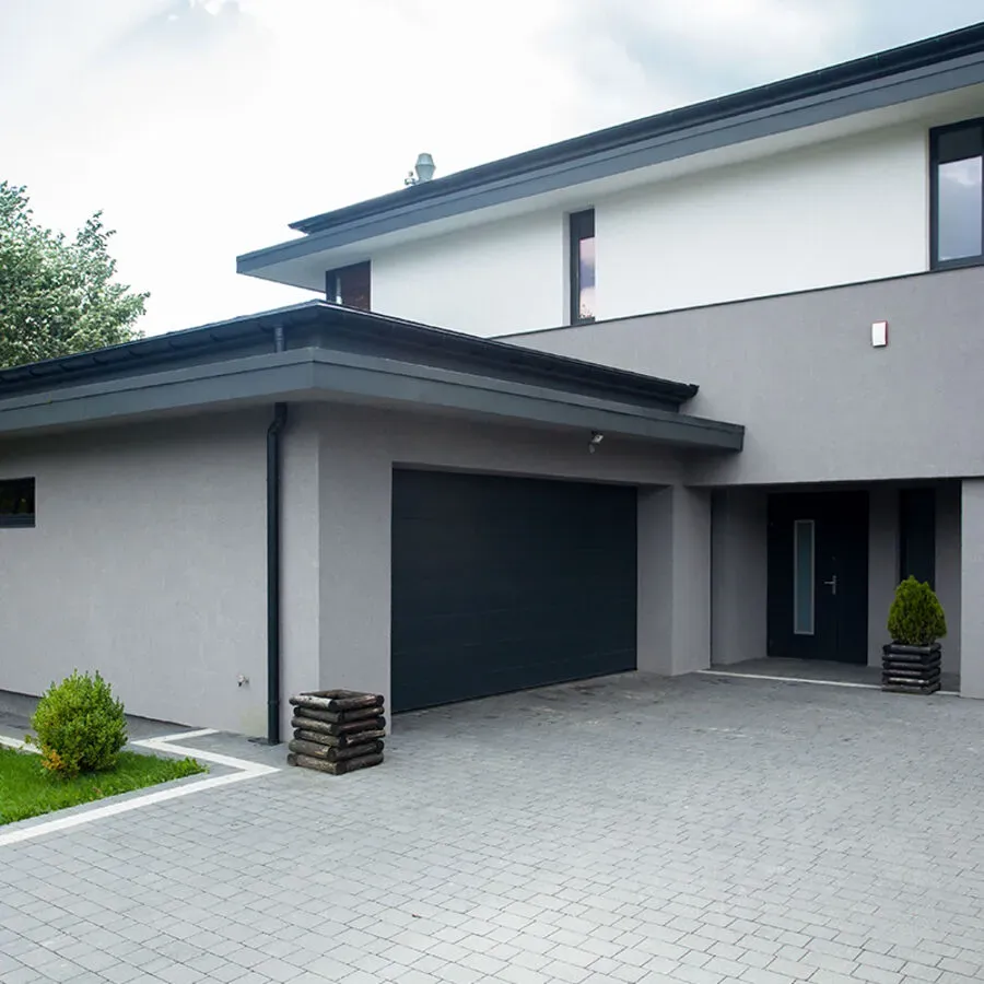A large white house with a black garage door
