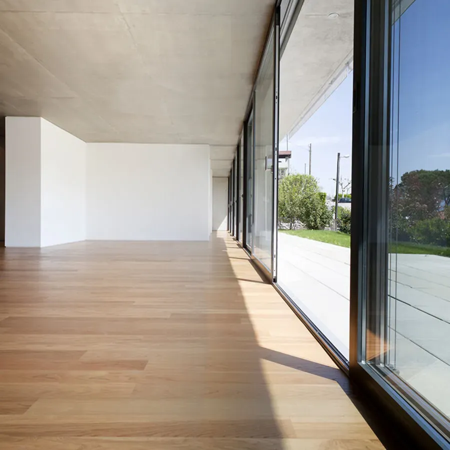 A large empty room with a lot of windows