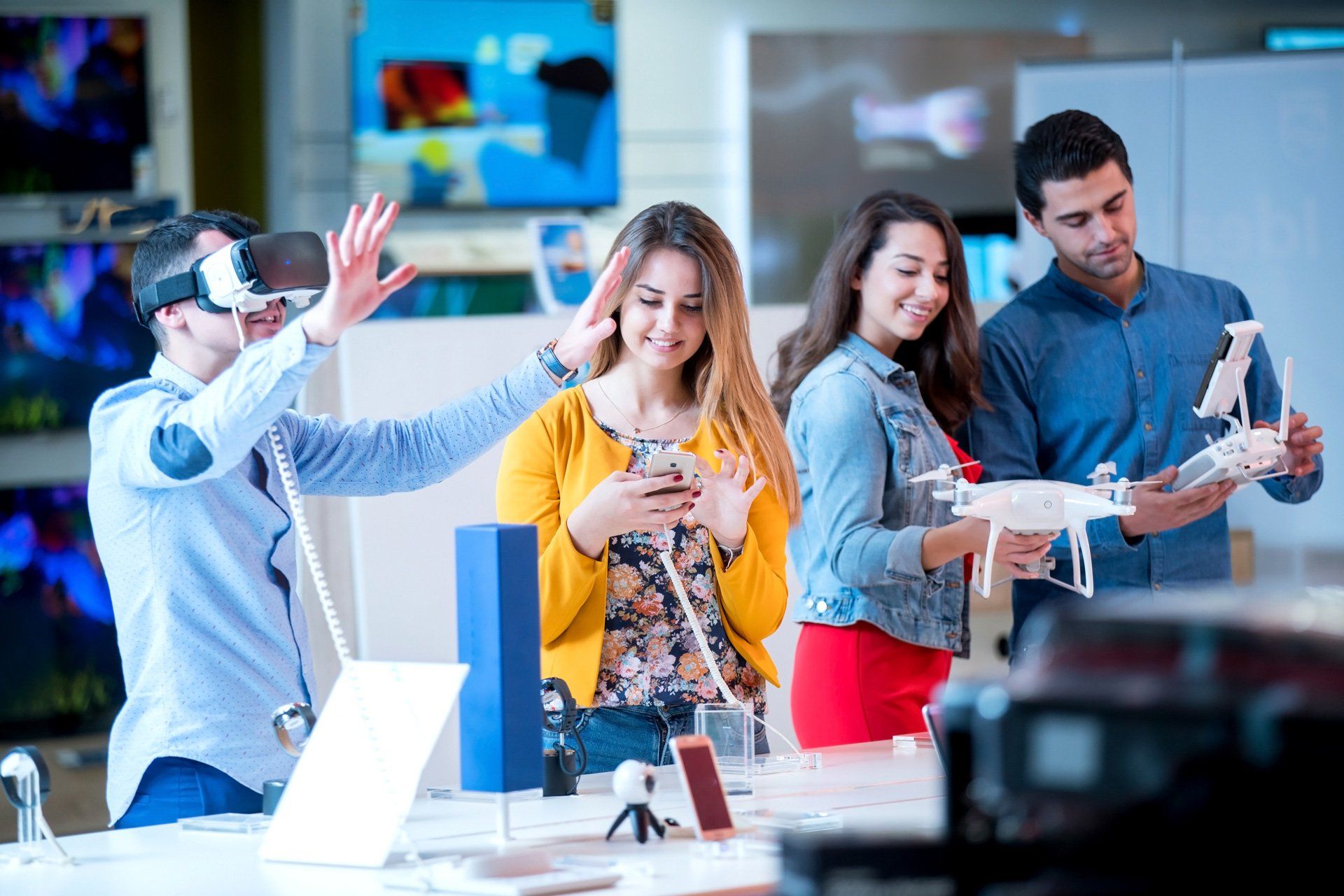 A group of people are looking at a drone in a store.