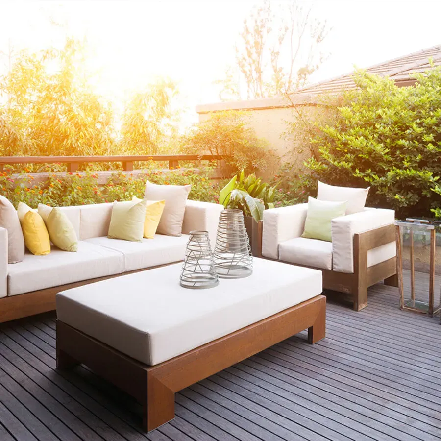 A patio with a couch , chairs and a coffee table